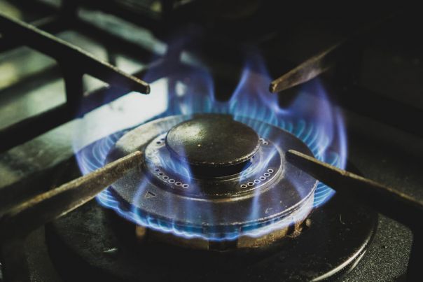 Gas cooktop with visible blue flame