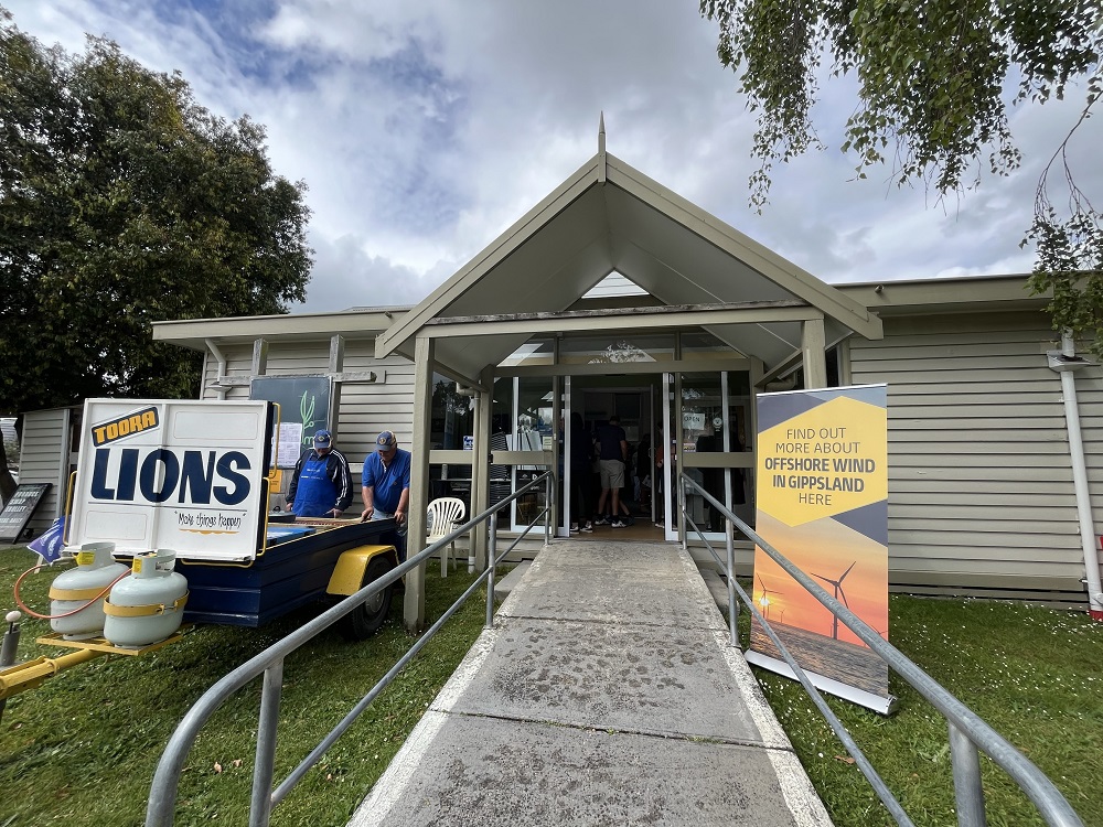 Gippsland Offshore Wind Days community session shows outside of building and two men setting up a barbecue for the Toora Lions  