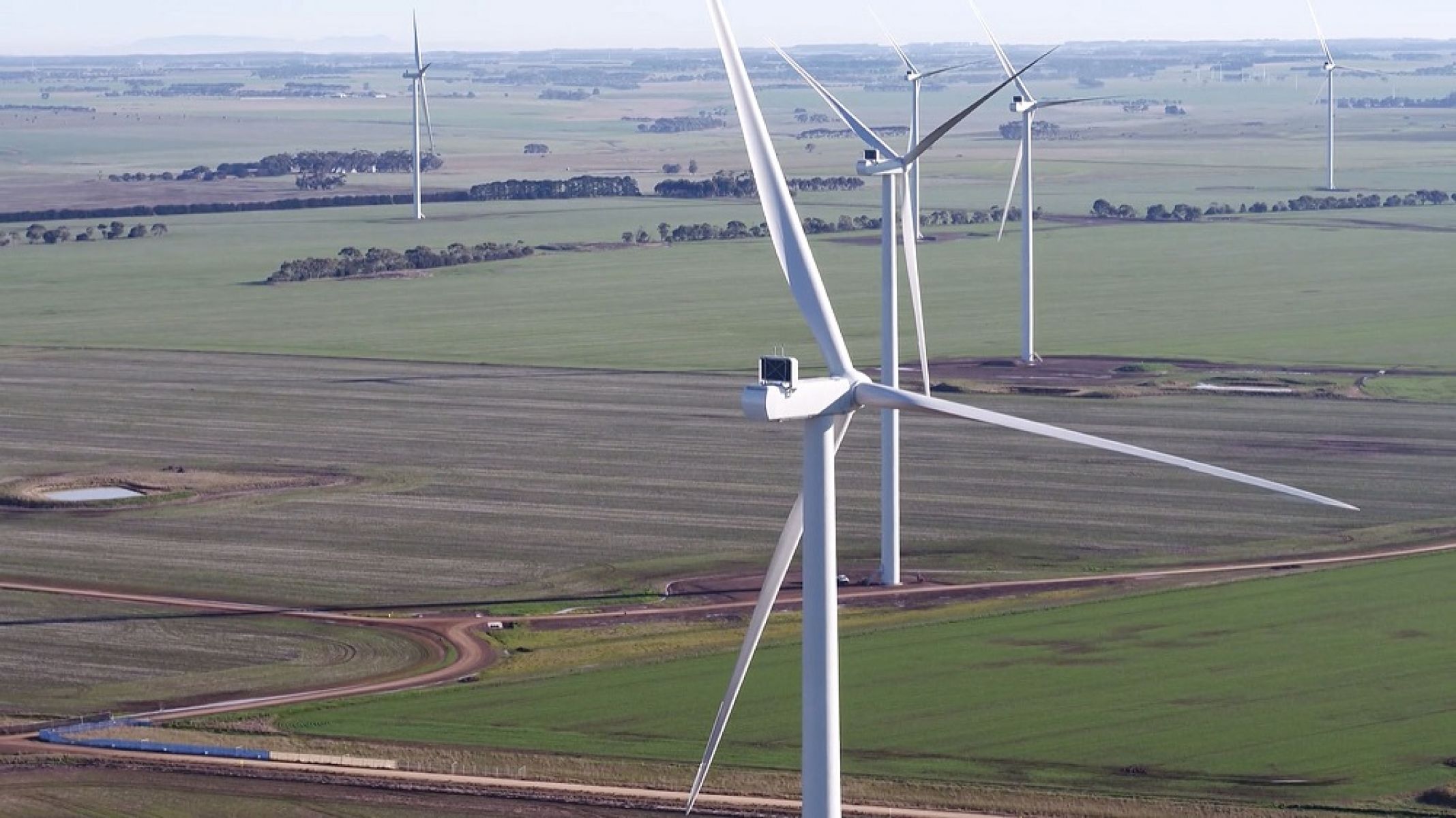 Aerial view of wind turbines above a field